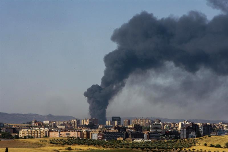 Una gran columna de humo aparece sobre el municipio de Chiloeches (Guadalajara), como consecuencia del incendio declarado en una planta de reciclado del polígono industrial. EFE/Pepe Zamora