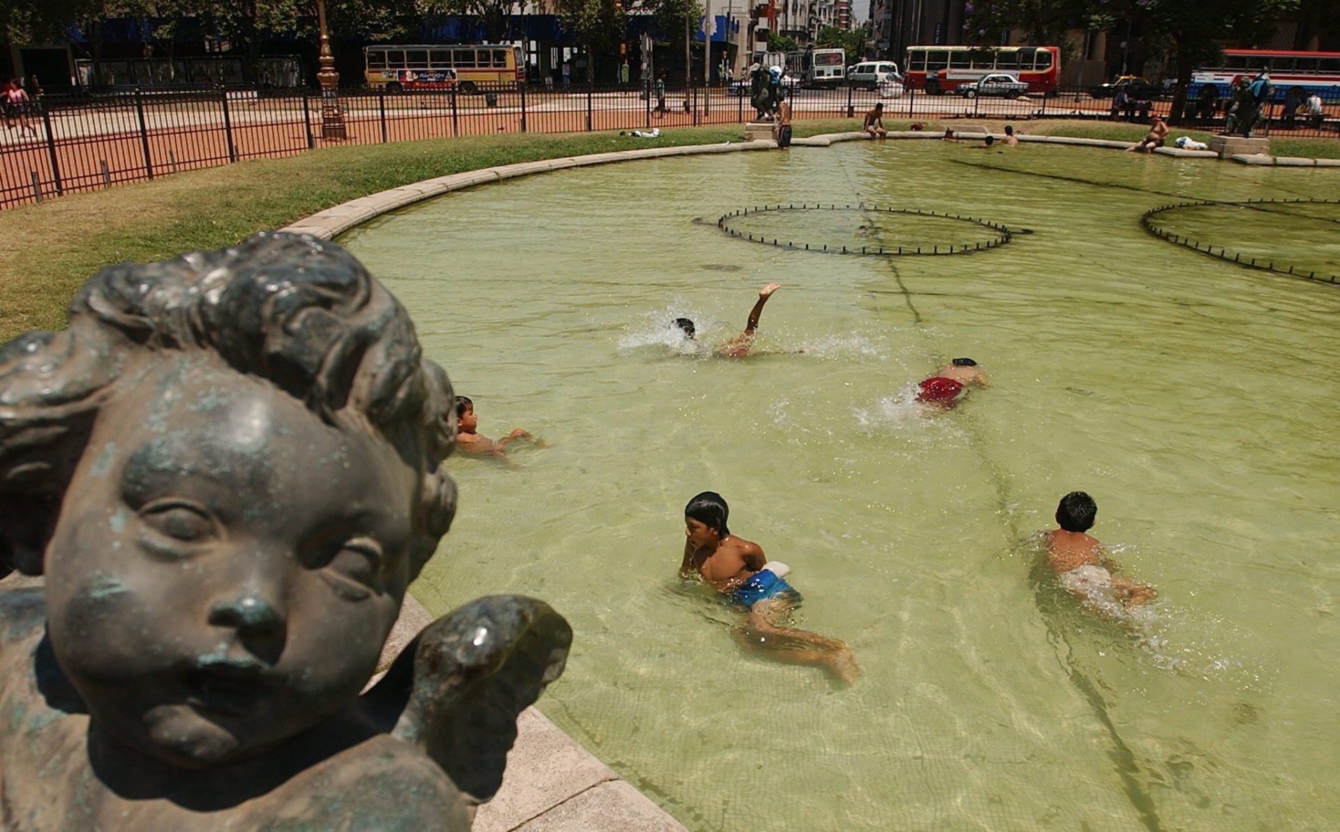 Unos niños se refrescan en una fuente del centro de Buenos Aires.