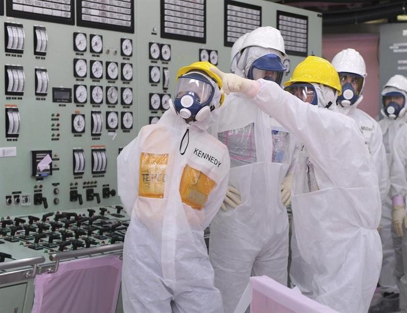La embajadora de EEUU en Japón, Caroline Kennedy (i), con traje y máscara antiradiación, durante su visita la semana pasada a la central de Fukushima.