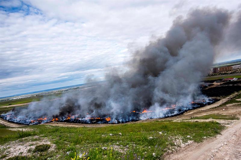 SESEÑA (TOLEDO), 14/05/2016.- Vista del incendio de neumáticos en Seseña (Toledo) cuyas labores de extinción continúan, aunque la gravedad de la alerta ha bajado y se ha levantado la orden de evacuación de los habitantes de la urbanización El Quiñón, pese a lo cual los pocos vecinos que han vuelto a su casa lo han hecho para recoger ropa y volver a irse. EFE/Ismael Herrero