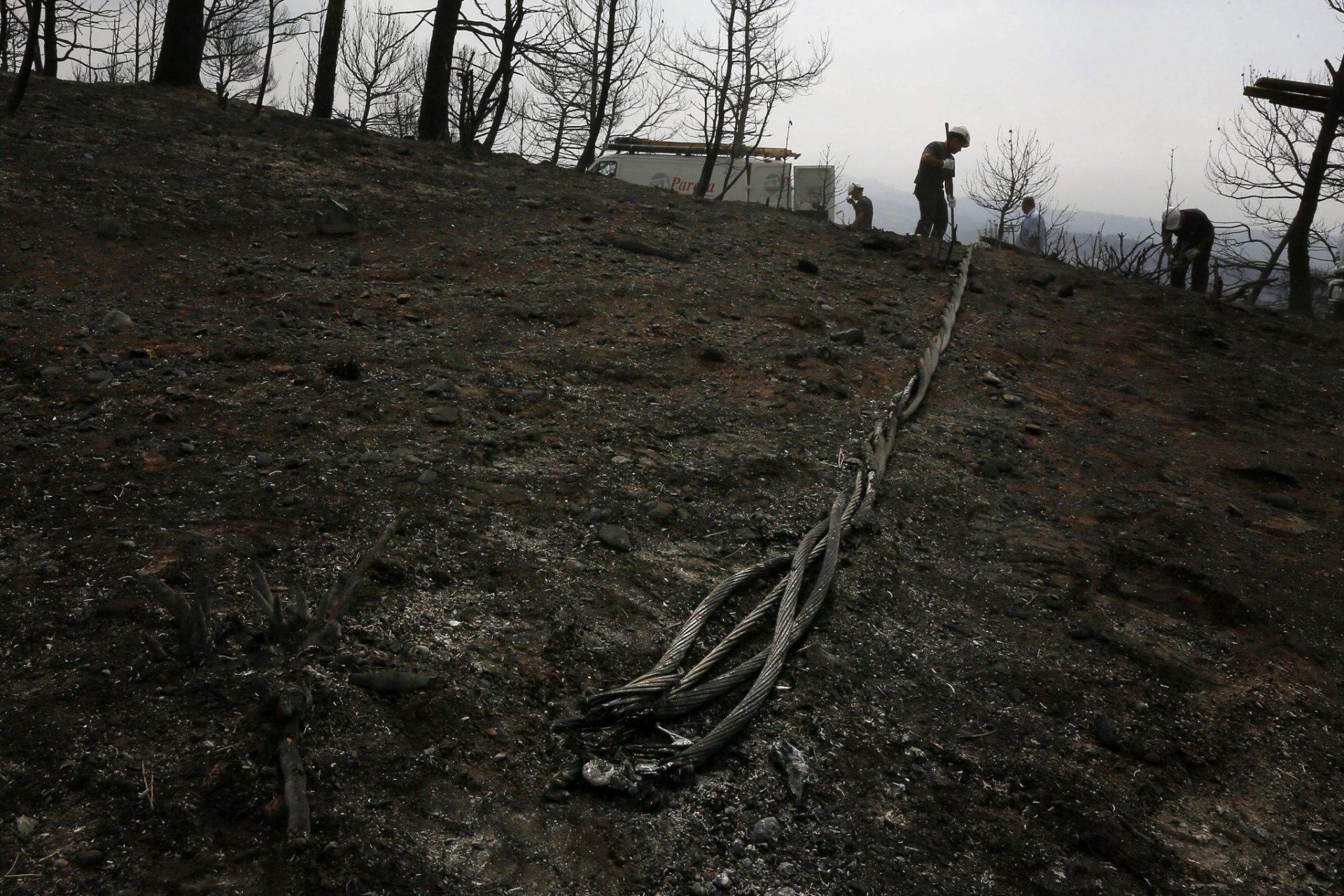 Trabajos sobre un tendido eléctrico quemado por el incendio de Òdena.