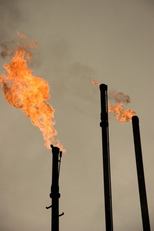 Burning flare stacks in Atacapi Station. The flare stacks are next to the Campo Libertador, a thick rainforest outside Lago Agrio, which ranges among the most bio-diverse jungles in the world. Companies operating in Ecuador's Amazonian oil fields pump 235,000 barrels of oil a day out of the rainforest and huge unlined pits of crude oil leach into the forest, streams and neighbouring farmland.   Sucumbios Province, Ecuador. Date Created:  Copyright Credit: © James Frankham / WWF
