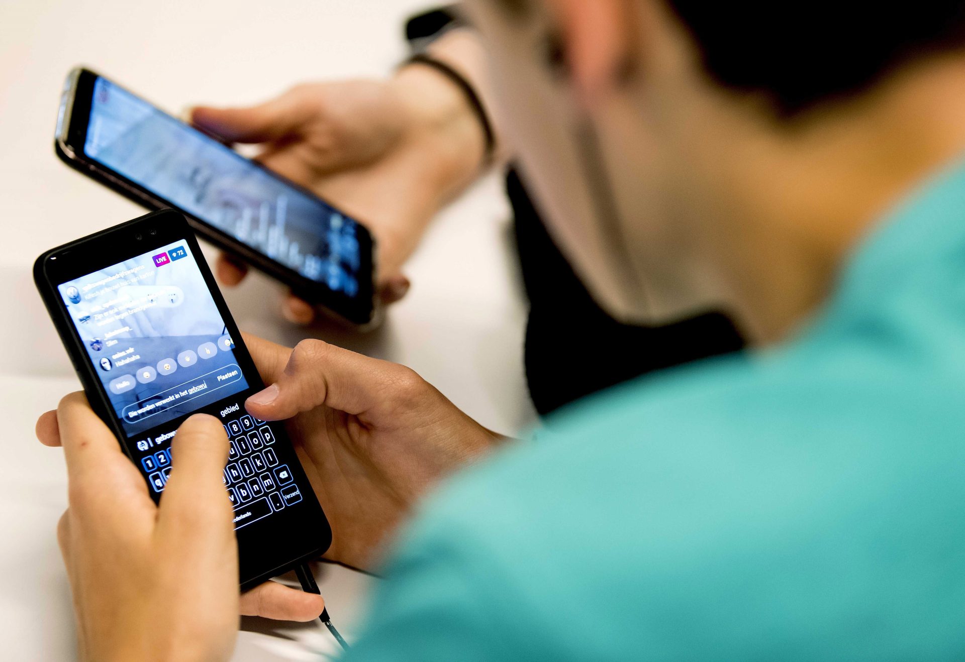 epa07645662 Students of the ROC Amsterdam watch a lesson on their smartphone, in Amsterdam, the Netherlands, 13 June 2019. Klassewerk is a new teaching method in which professionals give practical lessons to MBO students via Instagram Live. EPA/Koen van Weel