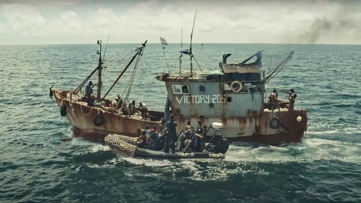 Rusty vessel Victory205 on the sea with speedboats Credit: Fábio Nascimento / The Outlaw Ocean Project Caption: In August 2019, a reporting team inspected a Chinese fishing vessel off the coast of West Africa. 